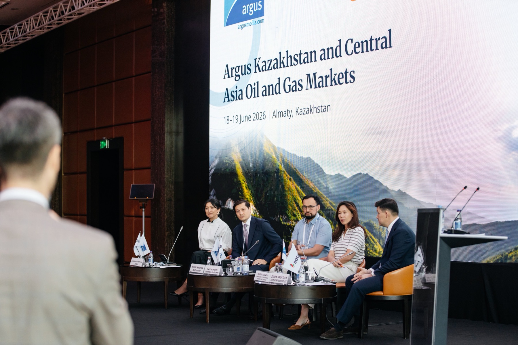 Conference stage during a panel session in Almaty