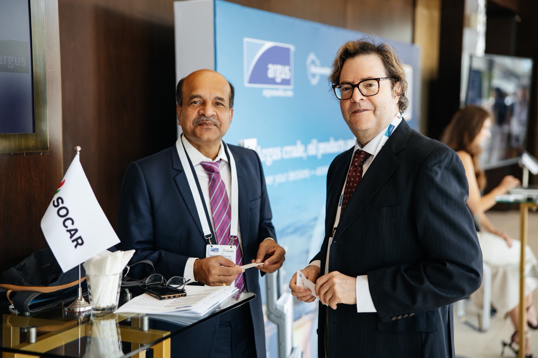 Steven Acosta exchanging business cards with a delegate at the Argus conference in Almaty